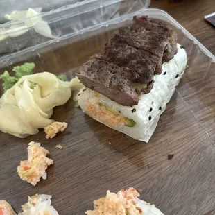 An actual cut up hamburger patty on top of what was supposed to be a filet mignon roll