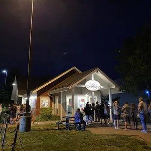 a crowd of people standing in front of a building