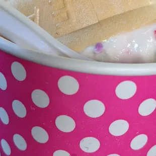 a hot dog in a polka dot cup