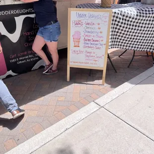a woman leaning against a sign