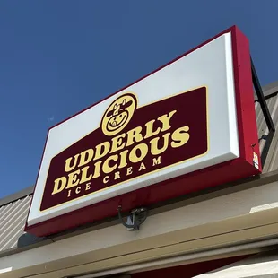 a sign for udderly delicious ice cream