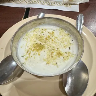 a bowl of soup and spoons