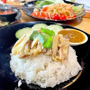a plate of rice with chicken and vegetables