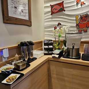 Self-service station: water, dipping sauces, condiments, napkins, utensils, etc