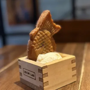 Taiyaki - crispy warm fish-shaped cake with sweet red bean filling, comes with vanilla ice cream in sake box