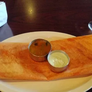 Andhra Special Dosai - 
 Thin rice crepe with a layer of spicy chutney. Topped with
 onions, chilies, and spicy masala.