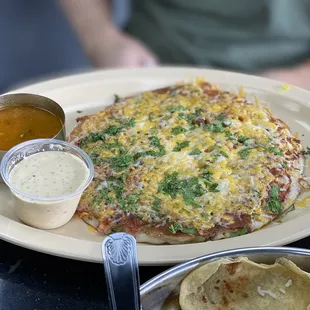 Cheese uthapam with onion and tomato chili toppings