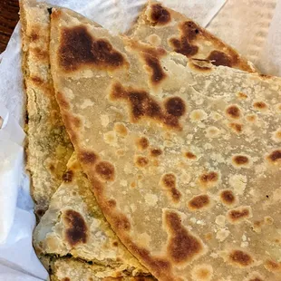 Close-up of alu paratha (soft, dense flatbread stuffed with potato): fresh, but not a lot of flavor, but still good