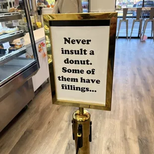 a sign in a donut shop
