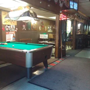 a pool table in the middle of the room