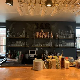 a bar with lots of bottles and glasses