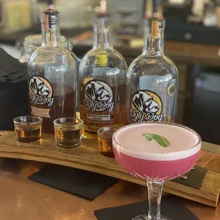 a pink cocktail in a coupe glass