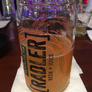 a glass of beer on a napkin