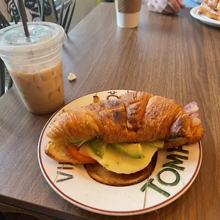 Croissant Breakfast Sandwich with avocado and bacon.