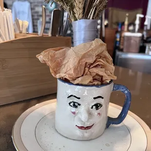 a cup with a face on it