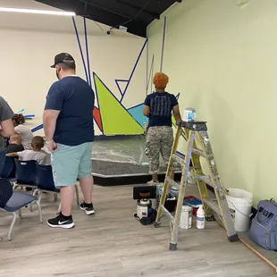 A mural being painted on opening day