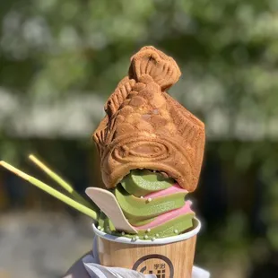 Matcha and Strawberry Rose (Seasonal) Icecream in a cone with Taiyaki on Top