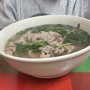 Pho , soup with with rice noodles and slices of beef