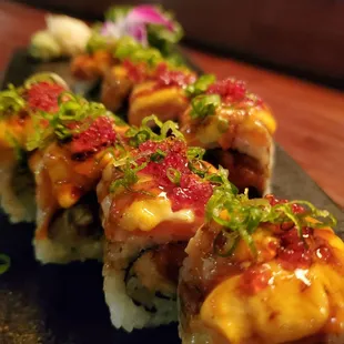 a sushi roll on a black plate