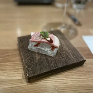 a piece of food on a wooden board