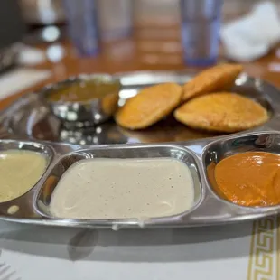 a plate of dips and crackers