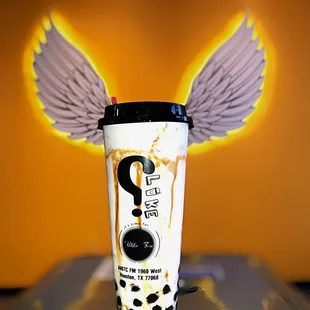 a cup with wings on top