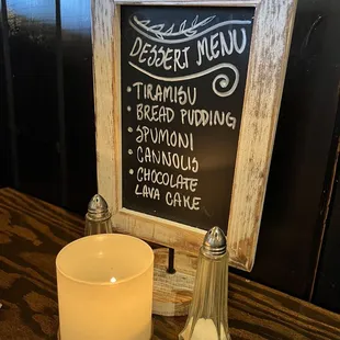 a candle and menu board