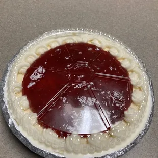 Medium cheesecake with strawberry topping.