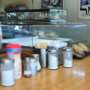 a wooden counter with salt and pepper shakers