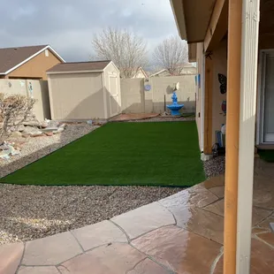 a patio area with artificial grass