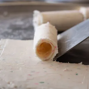 a person cutting a pastry