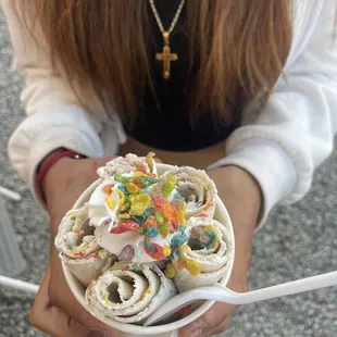 a person holding a bowl of ice cream