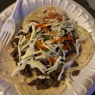 Carne asada tacos w/ pico, cabbage, and hot sauce.