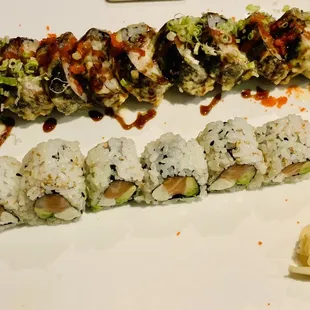 a plate of sushi rolls with sauce