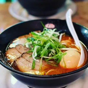 a bowl of soup with meat and vegetables