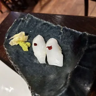 two pieces of sushi on a plate