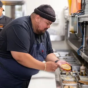 a man preparing food in a kitchen