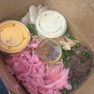 Wagyu beef rice bowl with x3 pickled onions, chicken , spicy orange sauce, garlic sesame soy sauce, and chili crunch!