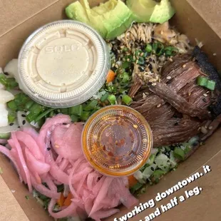 Wagyu beef rice bowl, pickled onions, chicken, avocado, garlic sesame soy sauce, and chili crunch.