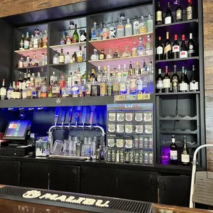 a bar with a lot of liquor bottles