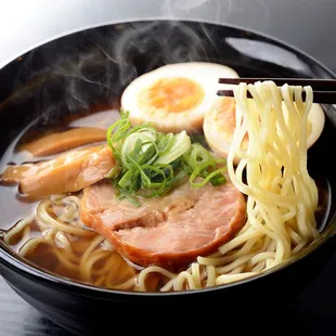 a bowl of ramen with chopsticks