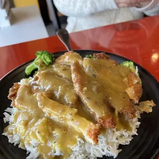 Chicken Katsu Curry Don - Fried chicken with curry sauce and broccoli, carrots, peas, onion served over a bowl of rice.