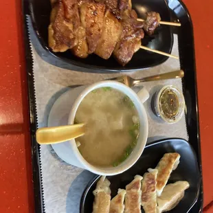 Gyoza, miso soup and chicken on a stick.