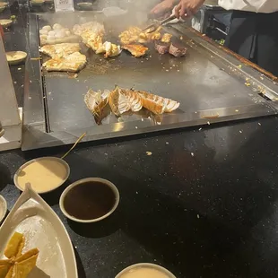 a man cooking food on a grill