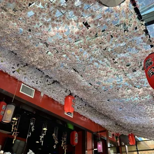 a ceiling covered in paper flowers