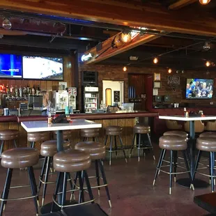 a bar with brown leather stools
