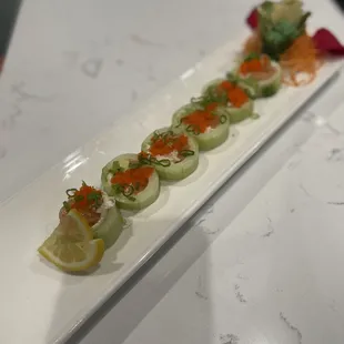 UMAMI Roll: Salmon, avocado, cream cheese, crabmeat, masago, and scallions wrapped in cucumber; served with ponzu sauce