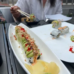 a woman eating sushi with chopsticks