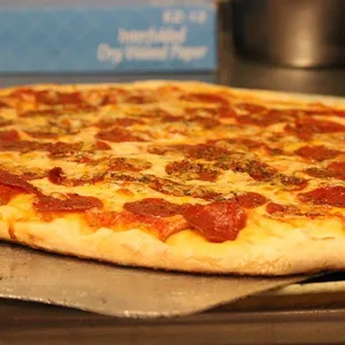 a pepperoni pizza on a pan