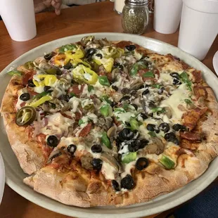 Supreme Pizza with added Jalapeños and banana peppers